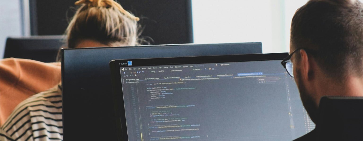 Hybrid Cloud Computing Two office workers utilizing a hybrid cloud computing setup