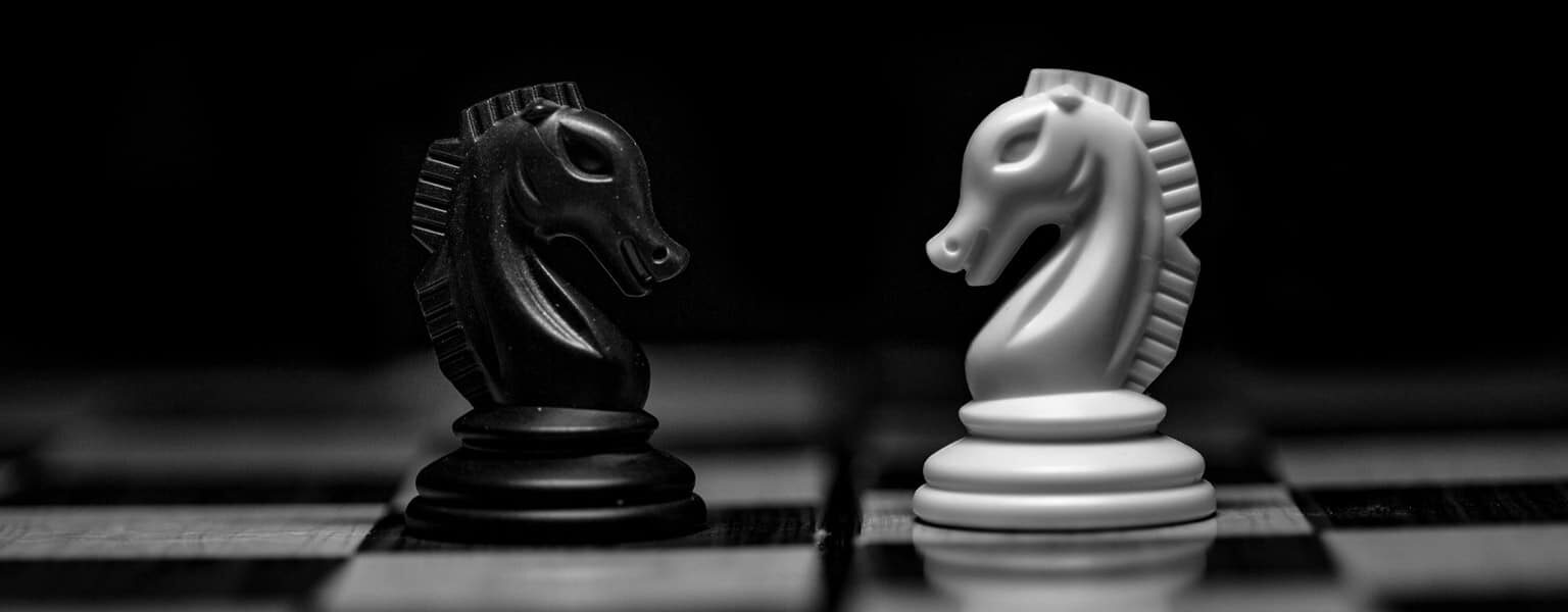 Two chess pieces depicting incident response vs cybersecurity monitoring